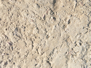 The texture of old concrete with stones frozen in it. Closeup