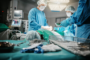 Surgery, doctor and nurse in hospital, theater and emergency room busy with operation in medical career. Employees, professional and healthcare with staff for transplant, medicine and health - obrazy, fototapety, plakaty