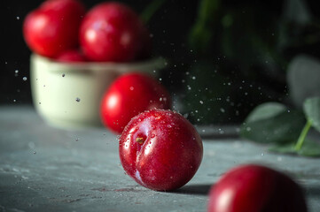 Free sweet red plums on dark background