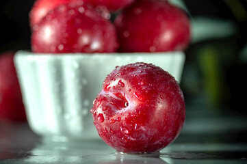 Free sweet red plums on dark background
