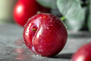 Free sweet red plums on dark background