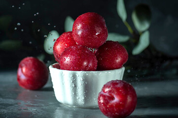 Free sweet red plums on dark background