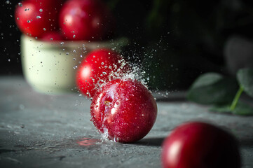 Free sweet red plums on dark background