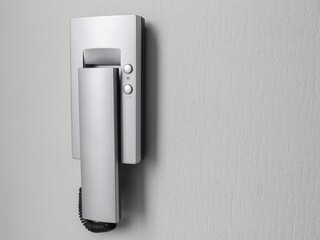 intercom receiver on a light-colored wall