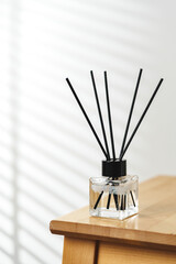 Modern Reed Diffuser on Wooden Table in Minimalist Interior During Daytime