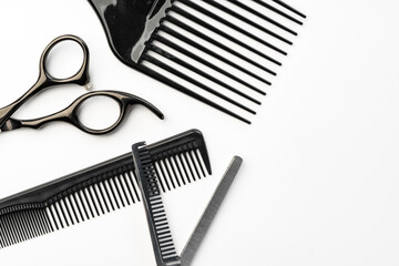 Black hairdressing tools and various hairbrushes on white background - 767634376