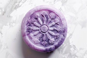 Obraz na płótnie Canvas Round handmade soap close-up from above on a marble background, with a carved lavender pattern and a purple-violet gradient.
