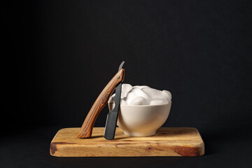 Classic Shaving Equipment With Razor, Brush, and Soap on Wooden Stand Against Dark Background