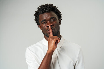 African Man Making a Hush Gesture With Finger