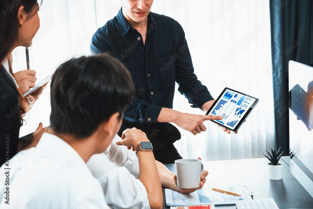 Fototapete Data analysts team of office worker collaborate on business intelligence BI dashboard to analyze financial, trend, and marketing data. BI software utilization drive business success. Prudent