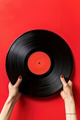 Glossy black vinyl record in hands against a bright red background, symbolizing the timeless contrast of music and silence