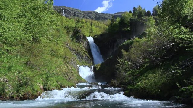 General view of the waterfall with the river in the foreground. 'Saut deth Pish' in the Aran Valley (Catalan Pyrenees)