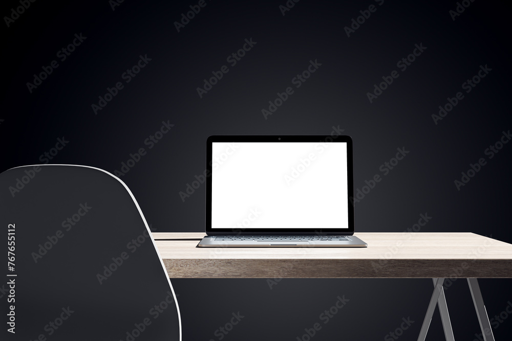 Poster close up of dark designer office desk with white mock up laptop on wooden table. 3d rendering.