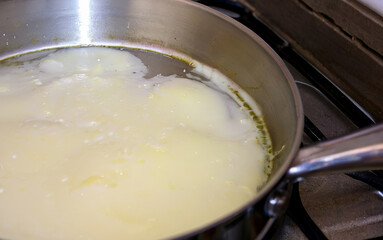 Melted tallow fat on pan
