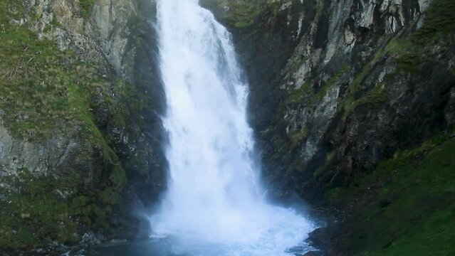 Medium shot with vertical panoramic camera movement from top to bottom of the waterfall. Saut deth Pish in the Aran Valley (Catalan Pyrenees)
