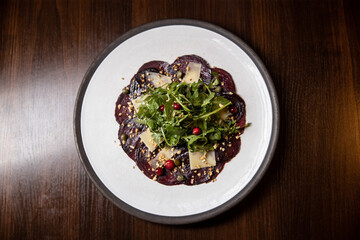 beetroot salad served dish in restaurant on dark background