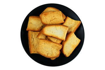 Slices of roasted bread on a black plate isolated on a white background