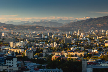 View of Tbilisi from the surrounding hills. In the background you can see the Caucasus Mountains. A warm autumn day in the capital of Georgia. - 767667527