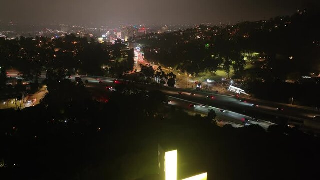 Hollywood Cross Illuminated At Night In Los Angeles, California - Aerial Ascending