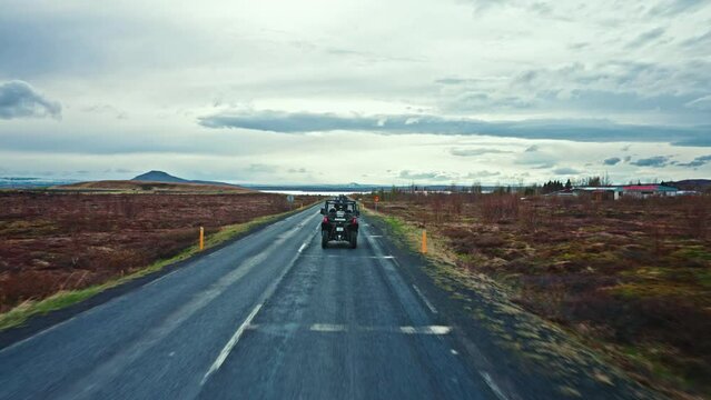 Column of ATV vehicles exploring the wild volcanic landscapes of Iceland. Buggies driving into rugged rocky terrain. Off-road quads excursion. Adventurous excursion into the wilderness.