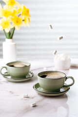 coffee cups with strong coffee on the table, spring atmosphere, space for text