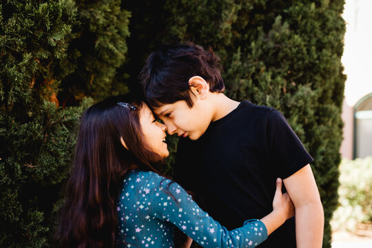 Sister Touches Forehead with Autistic Brother in San Diego