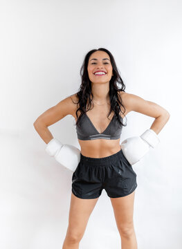 Beaming woman posing with boxing gloves