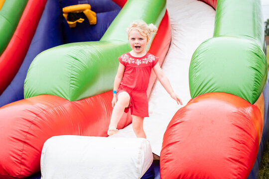 Happy child on inflatable bounce house at festival