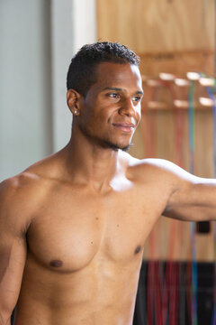Fit Man Smiling Shirtless in Gym