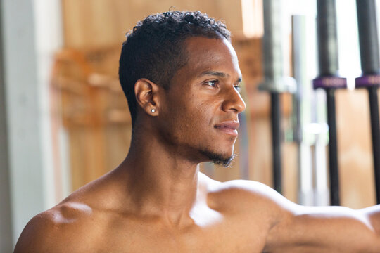 Fit Man Smiling Shirtless in Gym