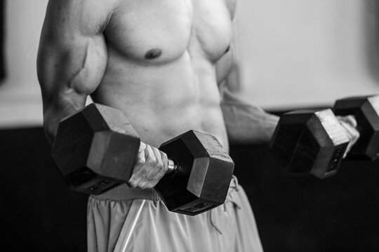 Shirtless Fit Man Lifting Hand Weights