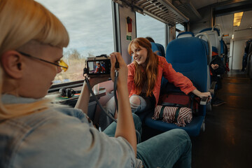 Friends photographing each other on a train © bernardbodo