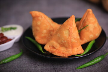 Samosa Indian famous street food snack closeup with selective focus and blur