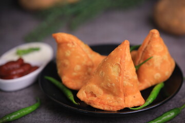Samosa Indian famous street food snack closeup with selective focus and blur