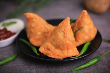 Samosa Indian famous street food snack closeup with selective focus and blur