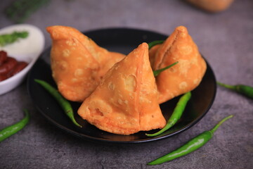 Samosa Indian famous street food snack closeup with selective focus and blur