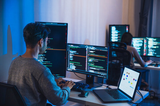 asian woman  and Indian man Developer team working  about devops programming software data online  at night in office