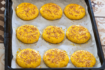 Savor the Flavor of Authenticity: Krashel, Carefully Prepared with Egg Brushing and Sesame, Ventures into the Oven, Promising a Taste of Moroccan Tradition!
