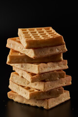 Belgian waffles isolated on black background