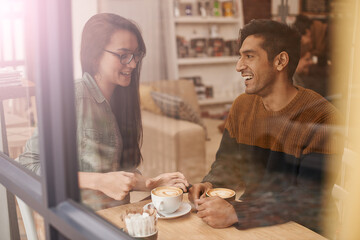 Coffee shop, date and and couple with drink in conversation, talking and chatting for bonding....