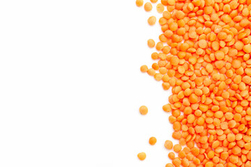 Uncooked red lentils border on white background. Copy space for text. Top view