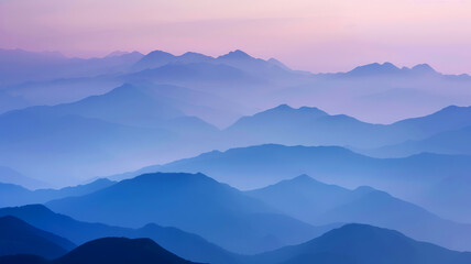 Tranquil Dawn Breaking Over Misty Mountain Ranges with Layers of Blue and Purple Hues