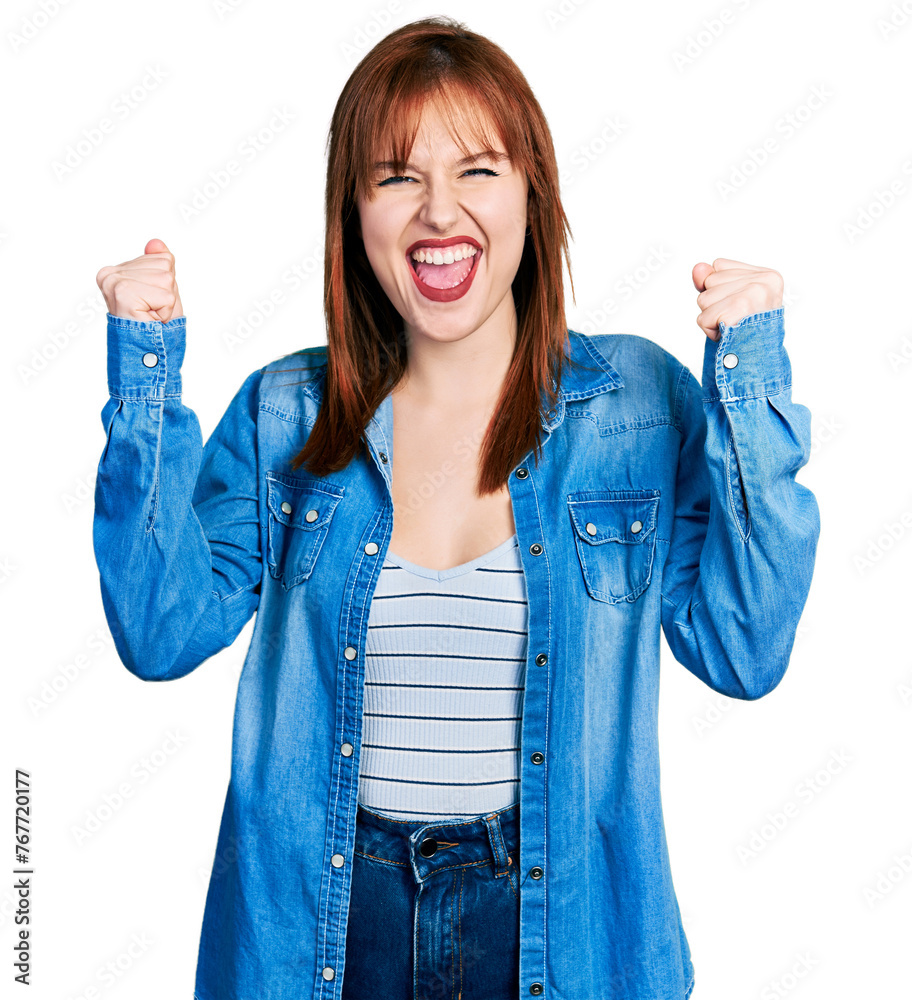 Sticker Redhead young woman wearing casual denim jacket celebrating surprised and amazed for success with arms raised and open eyes. winner concept.