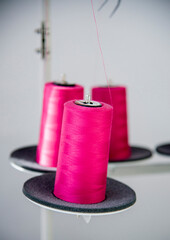  spools of different colored  thread and needle