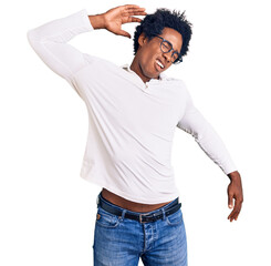 Handsome african american man with afro hair wearing casual clothes and glasses stretching back, tired and relaxed, sleepy and yawning for early morning