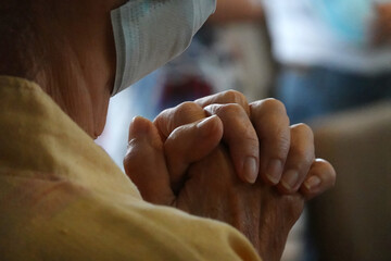 Human hands praying at Church.