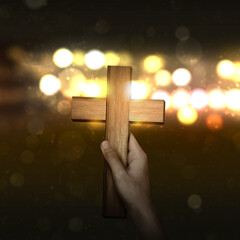 A human holding a Christian cross