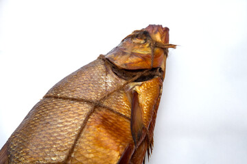 Smoked freshwater common bream fish for home use on white paper..