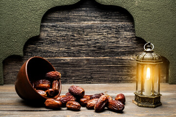 Arabic lantern and dried dates fruit for iftar on Ramadan in the bowl