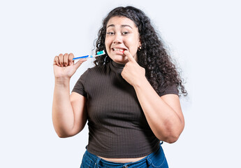 Girl suffering from gum pain holding toothbrush. Young woman with gingivitis holding toothbrush isolated. People holding toothbrush with gum problem - obrazy, fototapety, plakaty